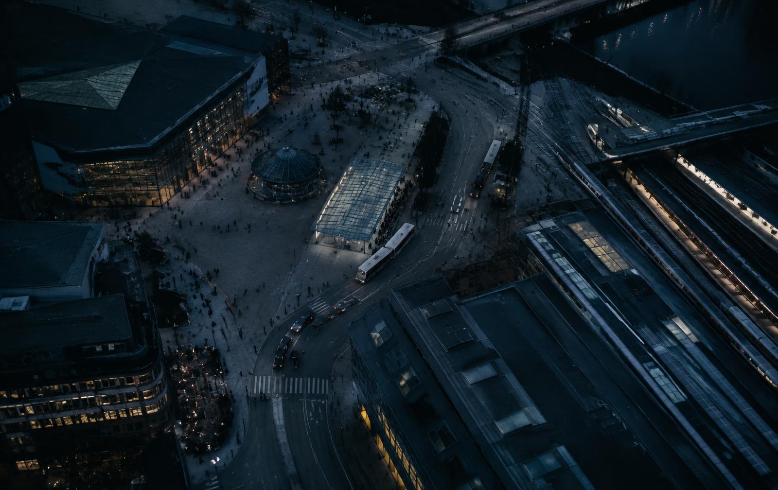 Aerial view of a city plaza and transit hub at dusk